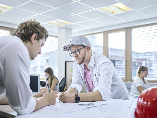 Zwei Männer zeichnen im modernen Bürogebäude - Businessfotograf Businessfotografie Christian Vorhofer